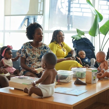 A group of women and children seated at a workshop