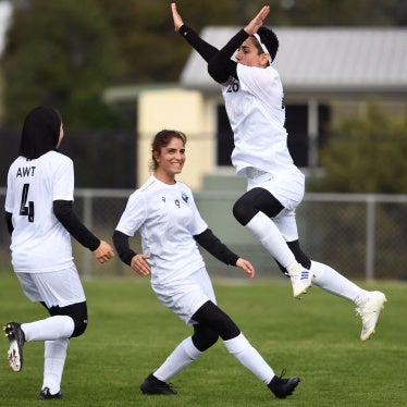 Afghan women's football team players celebrate a goal on April 24, 2022.