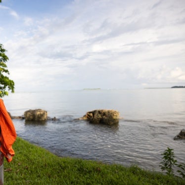 Community leader looks out to the seawall that has recently fallen apart and no longer protects the village of Walande, Malaita Province, Solomon Islands. 