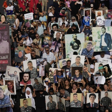 Relatives of the victims of the deadly 2020 Beirut blast hold portraits of their loved ones on the fourth anniversary of the blast, August 4, 2024.