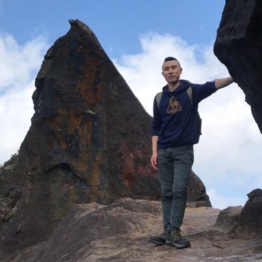 Fu Cha stands on the mountainside