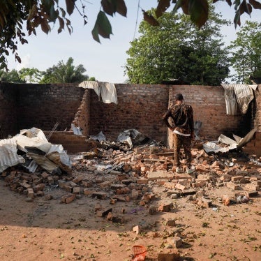 A man stands in front of a damaged and burnt house following a deadly gunmen attack in Yelwata, Benue State, Nigeria, June 16, 2025.