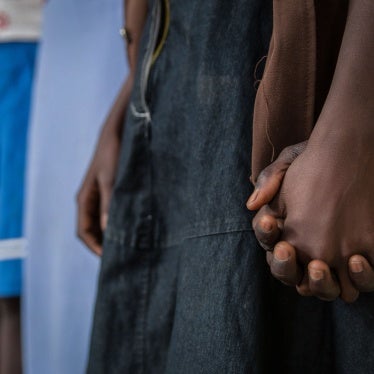 Girls who had been abducted by armed groups and forced to cook in captivity during conflict in Yambio, South Sudan, hold hands during a ceremony marking their release from captivity on February 7, 2018. 