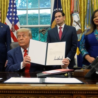 Trump holds up a signed document of the Rwanda DRC deal.