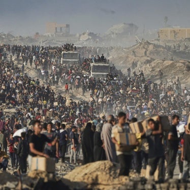  Palestinians carry food aid from a World Food Program convoy that was heading to Gaza City in the northern Gaza Strip, June 16, 2025. 