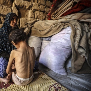 A woman consoles her 6-year-old daughter, who is malnourished, at a shelter in central Gaza City, on May 11, 2025.