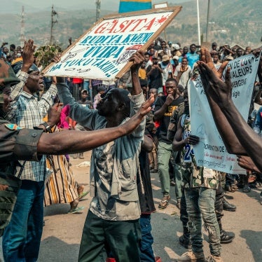 A protestor holds a placard in Uvira, DRC.