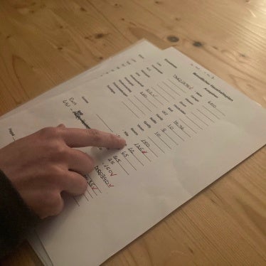 A single mother in low-wage work shows her monthly household budget to Human Rights Watch during an interview, Baden-Württemberg, February 2023.