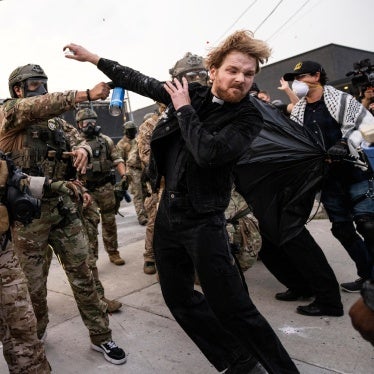 A federal immigration enforcement agent sprays Rev. David Black, of the First Presbyterian Church of Chicago, as he and other protesters demonstrate outside the US Immigration and Customs Enforcement facility in Broadview, Illinois, September 19, 2025.