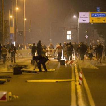  Caption: Right wing protesters who are against bringing asylum seekers to an accommodation facility run down a street in Heidenau, Germany August 22, 2015
