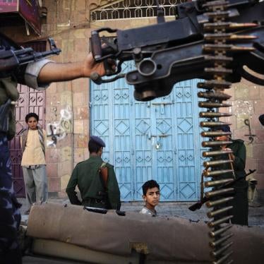 Police patrol al-Hasab neighborhood in the Yemeni city of Taizz on December 6, 2011.
