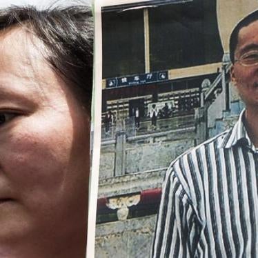 Wang Yanfang holds a portrait of her husband, Chinese human rights lawyer Tang Jingling, during a protest calling for his release. Tang received five years in prison for promoting nonviolent civil disobedience in January 2016.