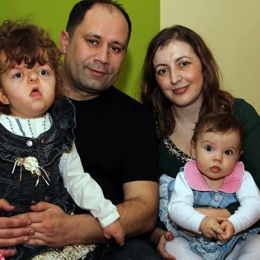 Julija Čuković, who spent ten months of her life in an institution, at home in Kragujevac with her parents, where she enjoys to play with her younger sister, also in the photo. © 2016 Zoran Stamenković
