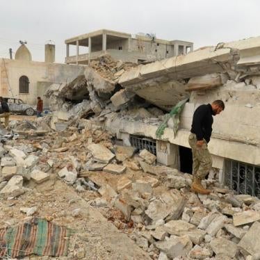 People inspect a damaged mosque after an airstrike on the rebel-held village of al-Jina, Aleppo province in northwest Syria March 17, 2017. 
