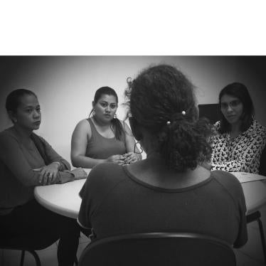 Staff from the Humanitarian Support Center for Women (CHAME, in Portuguese) listen to a woman in Boa Vista, Roraima, on February 17, 2017. CHAME provides legal, psychological, and social support to survivors of domestic violence. 