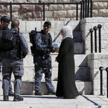 Israeli police check the identification card of a Palestinian woman at Damascus Gate in the Israeli occupied Old City of Jerusalem. © 2016 Ammar Awad/Reuters 