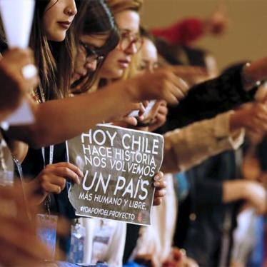 Demonstrators raise their thumbs in approval during a rally inside congress in favor of a draft law that would ease the country's strict abortion ban, in Valparaiso, March 17, 2016. 