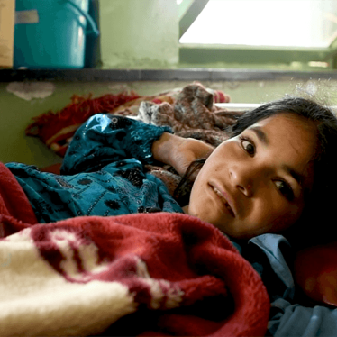 a photo of a child on a hospital bed in Afghanistan.