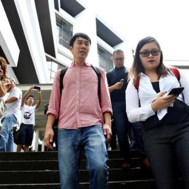 Activist Jolovan Wham (center) leaves the State Court after a hearing in Singapore, November 29, 2017. © 2017 REUTERS/Edgar Su