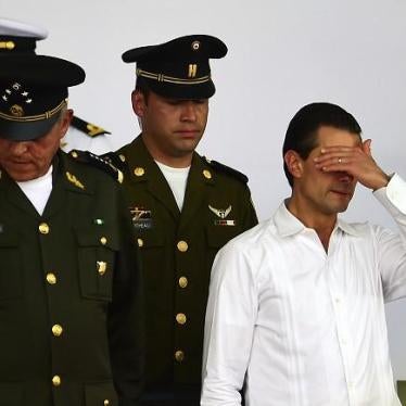 Mexican President Enrique Pena Nieto (R) gestures during an event for the National Flag Day in Iguala, Guerrero State, Mexico on February 24, 2016. 