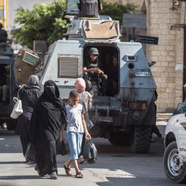 A picture taken on July 26, 2018 shows Egyptian policemen stand guarding a street in the North Sinai provincial capital of El-Arish. With fruit and vegetables aplenty in the markets, public transport back on the roads and universities reopened, life is re