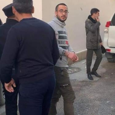 Policemen bringing youth activist Bayram Mammadov to the Appeal Court in Baku, Azerbaijan. April 2, 2019. 