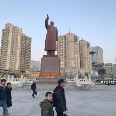 Pedestrians walk by a statue of former Chinese leader Mao Zedong outside the railway station in the Chinese city of Dandong bordering North Korea in northeastern China's Liaoning Province, Saturday, Feb. 23, 2019. 