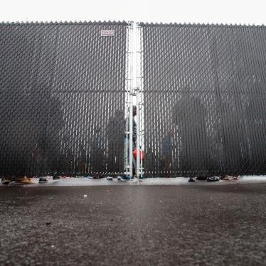 People wait in a temporary detention center in Blackpool, Quebec, August 5, 2017.