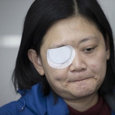 In this Wednesday, Dec. 4, 2019, photo, Veby Mega Indah, an injured Indonesian video journalist, bites her lips during an interview with The Associated Press in the Wan Chai area of Hong Kong.