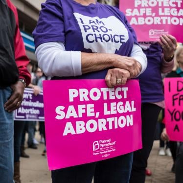 An activist seen holding a placard that reads, "protect safe, legal abortion" during a Stop the Bans rally in Dayton, Ohio, May 19, 2019.