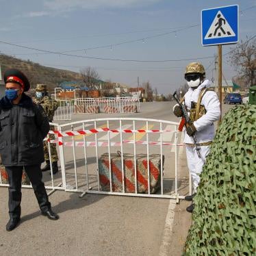 Kyrgyz law enforcement officers verify drivers and passengers' documents at a check point, after authorities declared a state of emergency in the capital Bishkek.